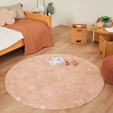 Round pink washable rug made of cotton